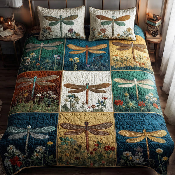 Dragonfly Serenity quilted 3-piece bedding set on a made bed with two matching pillow shams