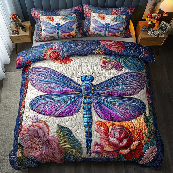 Dragonfly Sparkle quilted 3-piece bedding set on a made bed with two matching pillow shams