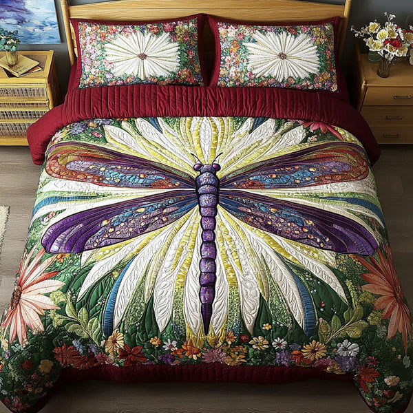 Dragonfly Symphony quilted 3-piece bedding set on a made bed with two matching pillow shams
