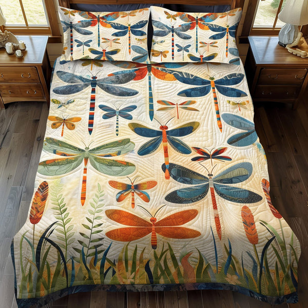 Dragonfly Whisper quilted 3-piece bedding set on a made bed with two matching pillow shams