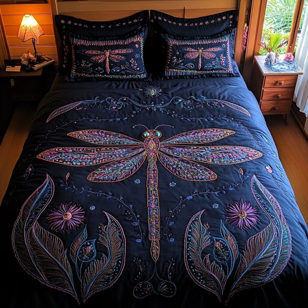 Dragonfly Whisper quilted 3-piece bedding set on a made bed with two matching pillow shams