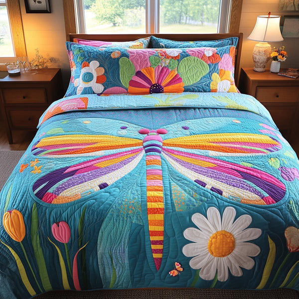 Dragonfly Whisper quilted 3-piece bedding set on a made bed with two matching pillow shams