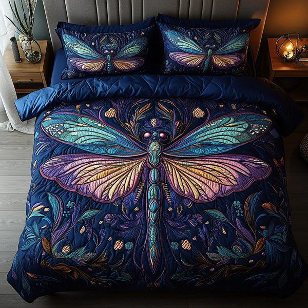 Dragonfly Whispers quilted 3-piece bedding set on a made bed with two matching pillow shams