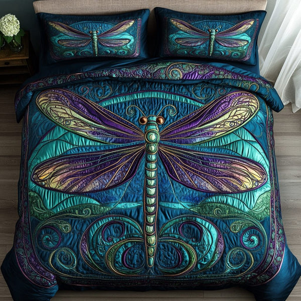 Dragonfly Wings quilted 3-piece bedding set on a made bed with two matching pillow shams