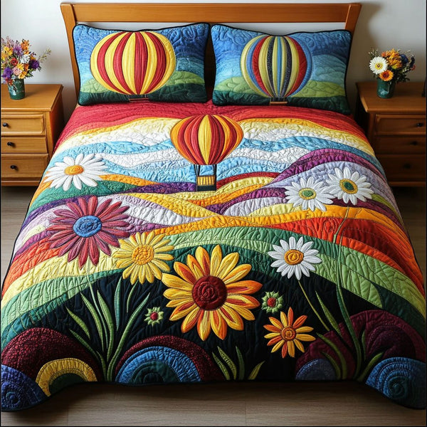 Dreamscape Journey quilted 3-piece bedding set on a made bed with two matching pillow shams