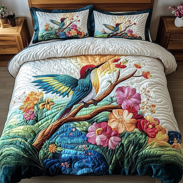 Dreamy Hummingbird quilted 3-piece bedding set on a made bed with two matching pillow shams