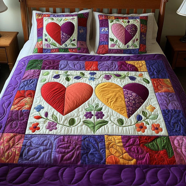 Dual Bloom Hearts quilted 3-piece bedding set on a made bed with two matching pillow shams