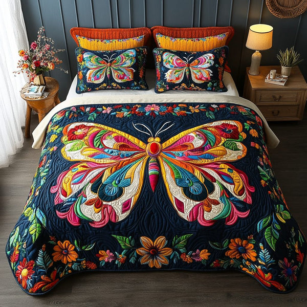 Dusk Wings quilted 3-piece bedding set on a made bed with two matching pillow shams