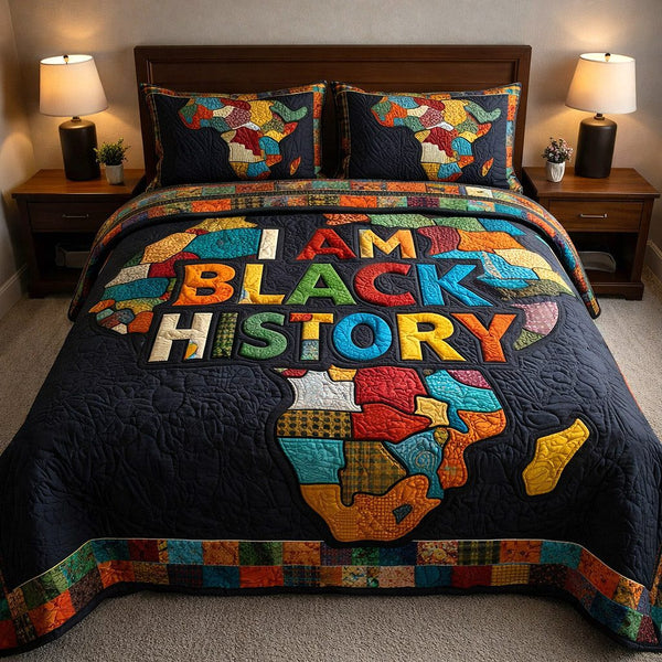 Ebony Glow quilted 3-piece bedding set on a made bed with two matching pillow shams
