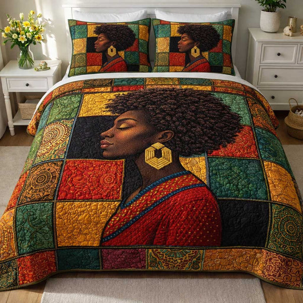Ebony Queen quilted 3-piece bedding set on a made bed with two matching pillow shams