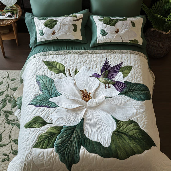 Elegant Bloom quilted 3-piece bedding set on a made bed with two matching pillow shams