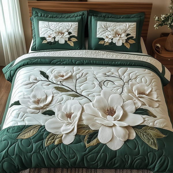 Elegant Blooming Magnolia quilted 3-piece bedding set on a made bed with two matching pillow shams