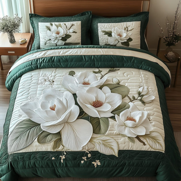 Elegant Blooming Magnolia quilted 3-piece bedding set on a made bed with two matching pillow shams