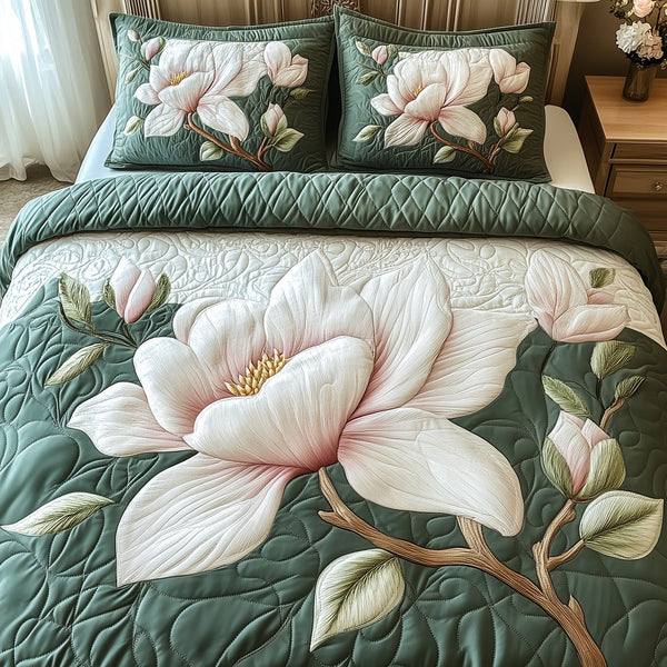 Elegant Blooming Magnolia quilted 3-piece bedding set on a made bed with two matching pillow shams