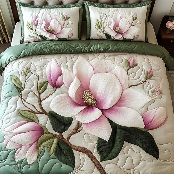 Elegant Blooming Magnolia quilted 3-piece bedding set on a made bed with two matching pillow shams