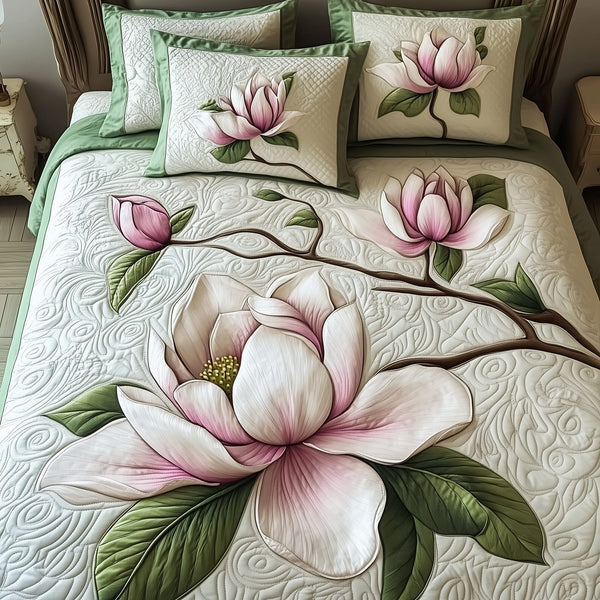 Elegant Blooming Magnolia quilted 3-piece bedding set on a made bed with two matching pillow shams