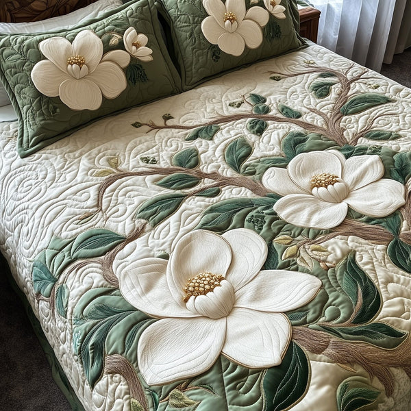 Elegant Blooming Magnolia quilted 3-piece bedding set on a made bed with two matching pillow shams