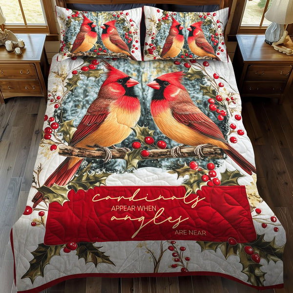 Elegant Cardinals quilted 3-piece bedding set on a made bed with two matching pillow shams