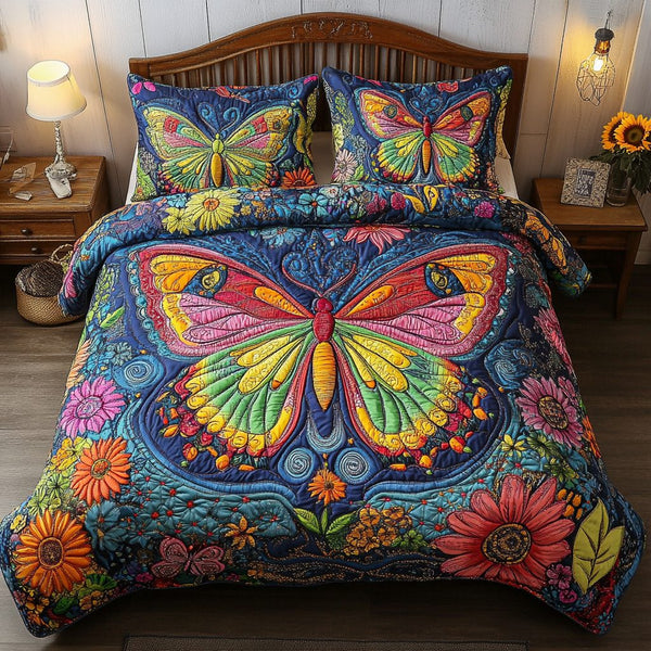 Elegant Escape quilted 3-piece bedding set on a made bed with two matching pillow shams