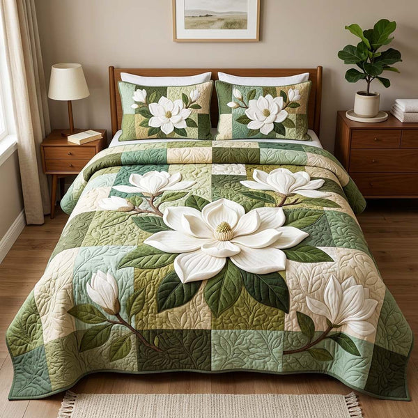 Elegant Magnolia quilted 3-piece bedding set on a made bed with two matching pillow shams