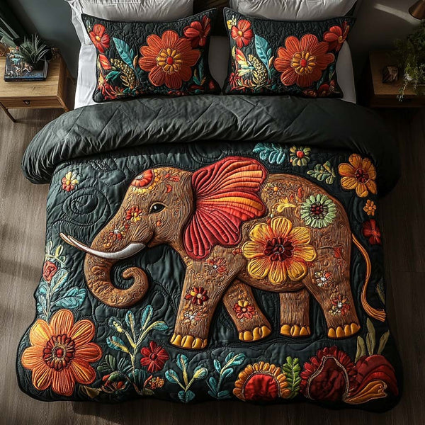 Elephant Meadow Bliss quilted 3-piece bedding set on a made bed with two matching pillow shams