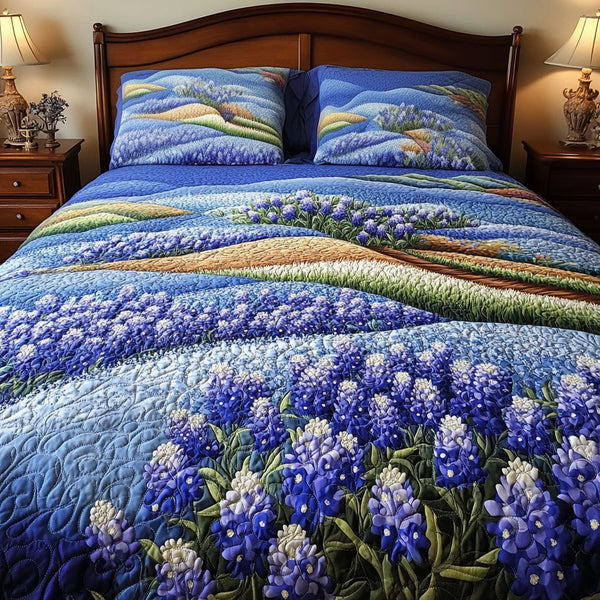 Endless Bluebonnet Fields quilted 3-piece bedding set on a made bed with two matching pillow shams