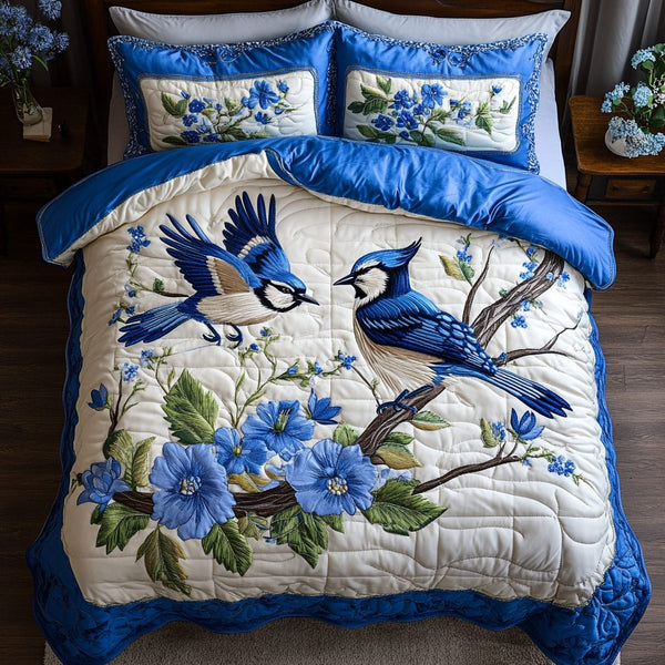 Feather Bloom quilted 3-piece bedding set on a made bed with two matching pillow shams
