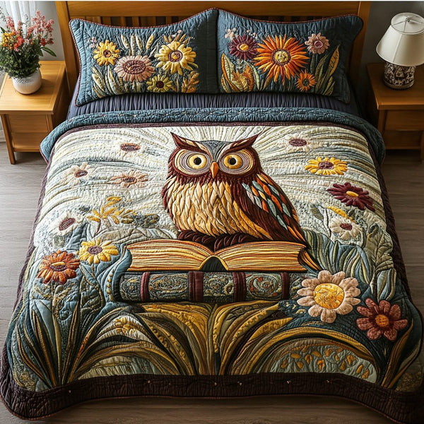 Feathered Friend quilted 3-piece bedding set on a made bed with two matching pillow shams