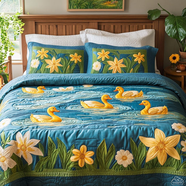 Feathered Friends quilted 3-piece bedding set on a made bed with two matching pillow shams
