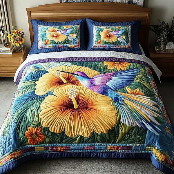 Feathered Paradise quilted 3-piece bedding set on a made bed with two matching pillow shams