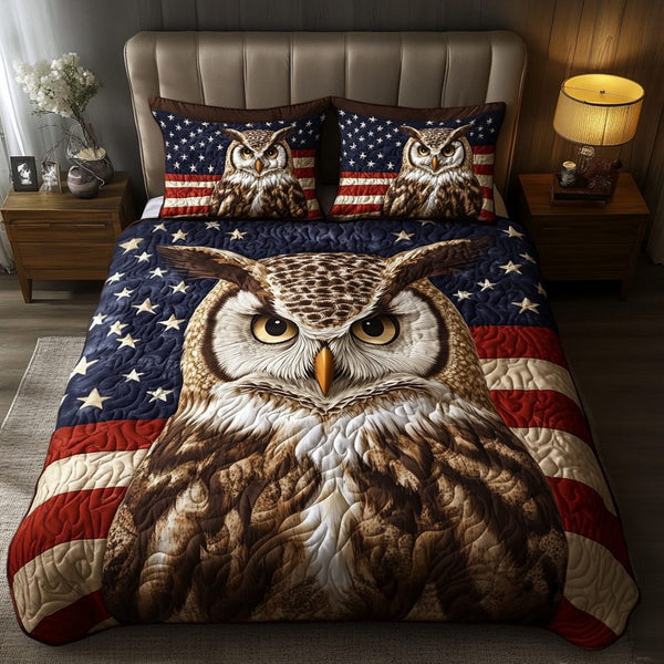 Feathered Sage quilted 3-piece bedding set on a made bed with two matching pillow shams