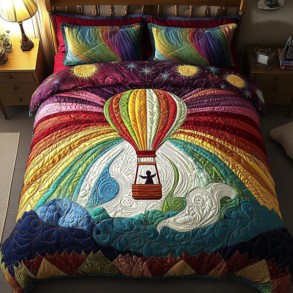 Floating Dreams quilted 3-piece bedding set on a made bed with two matching pillow shams