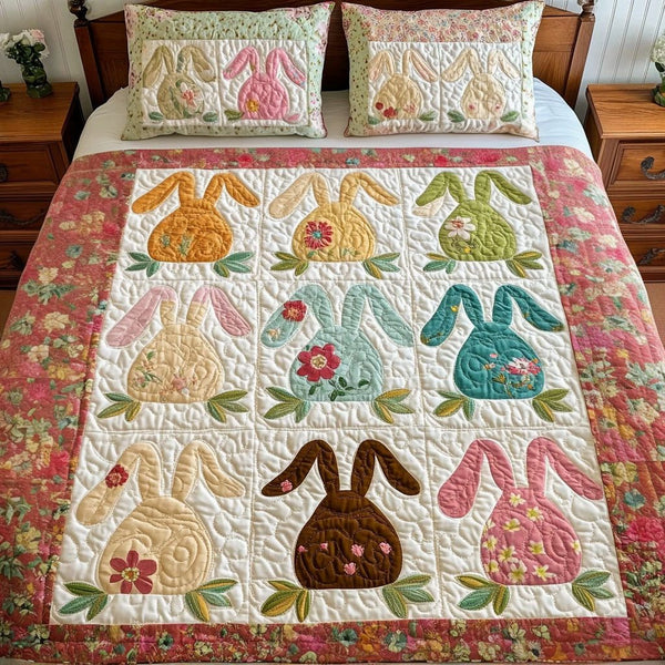 Floral Bunny Garden quilted 3-piece bedding set on a made bed with two matching pillow shams