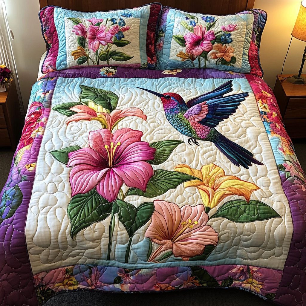 Floral Flight quilted 3-piece bedding set on a made bed with two matching pillow shams