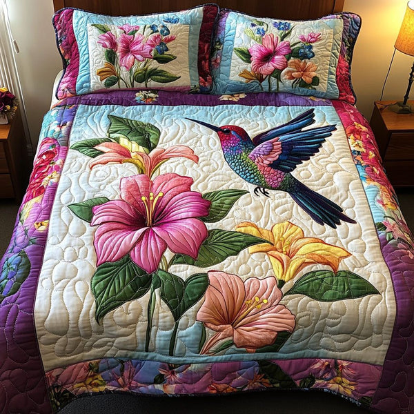 Floral Flight quilted 3-piece bedding set on a made bed with two matching pillow shams