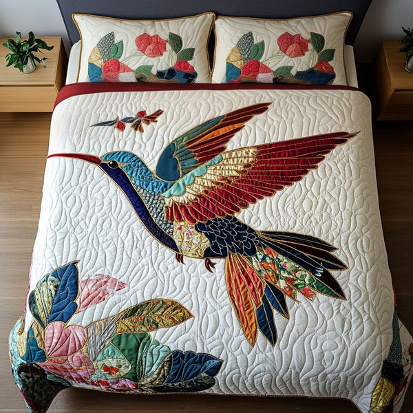 Floral Flight quilted 3-piece bedding set on a made bed with two matching pillow shams