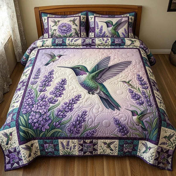 Floral Hummingbird quilted 3-piece bedding set on a made bed with two matching pillow shams
