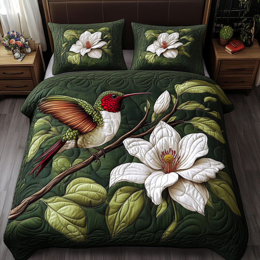 Floral Hummingbird quilted 3-piece bedding set on a made bed with two matching pillow shams