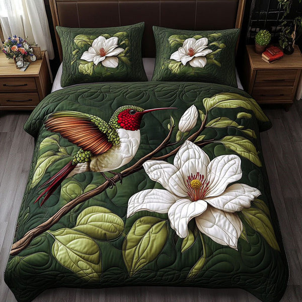 Floral Hummingbird quilted 3-piece bedding set on a made bed with two matching pillow shams