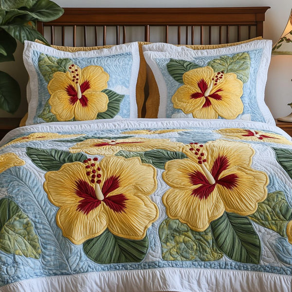 Floral Paradise quilted 3-piece bedding set on a made bed with two matching pillow shams
