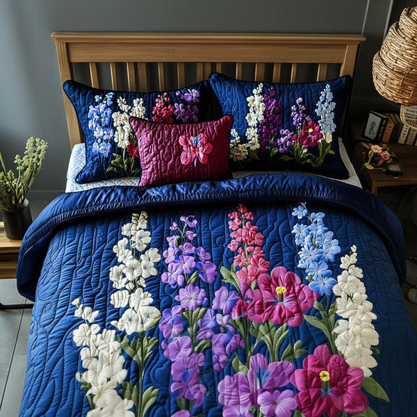 Floral Reflection quilted 3-piece bedding set on a made bed with two matching pillow shams