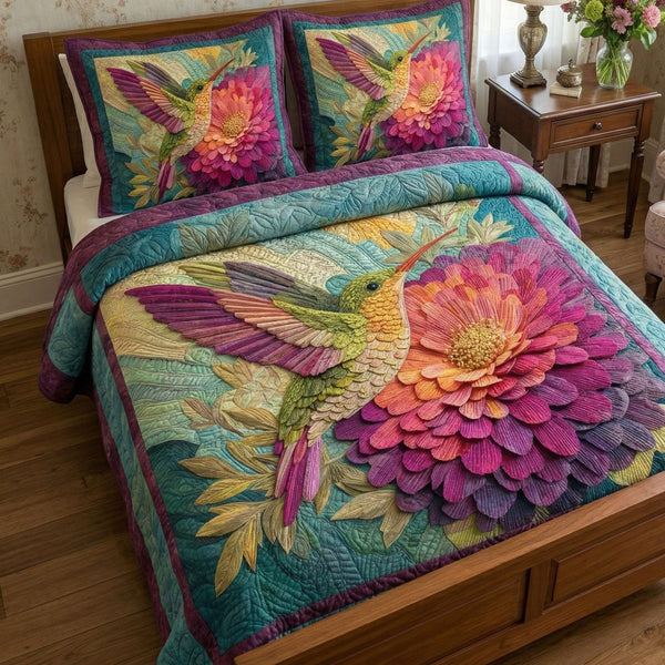 Floral Zinnia Glow quilted 3-piece bedding set on a made bed with two matching pillow shams