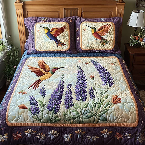 Fluttering Beauty quilted 3-piece bedding set on a made bed with two matching pillow shams
