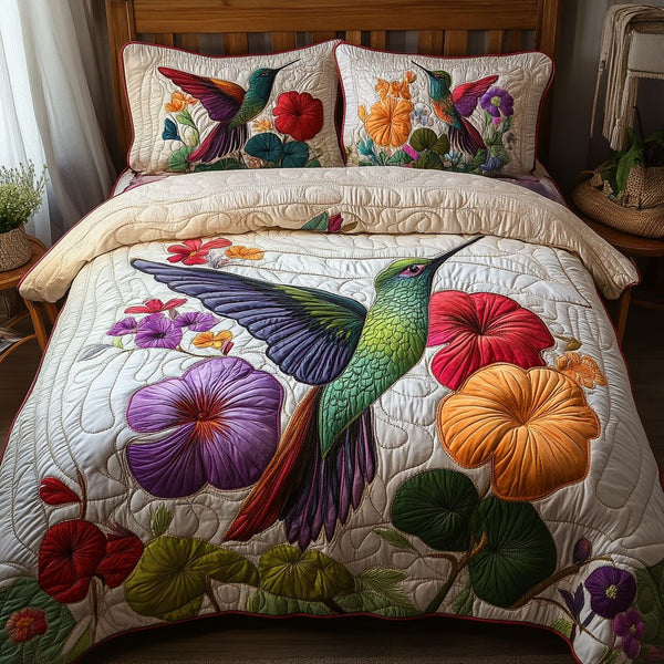 Fluttering Symphony quilted 3-piece bedding set on a made bed with two matching pillow shams