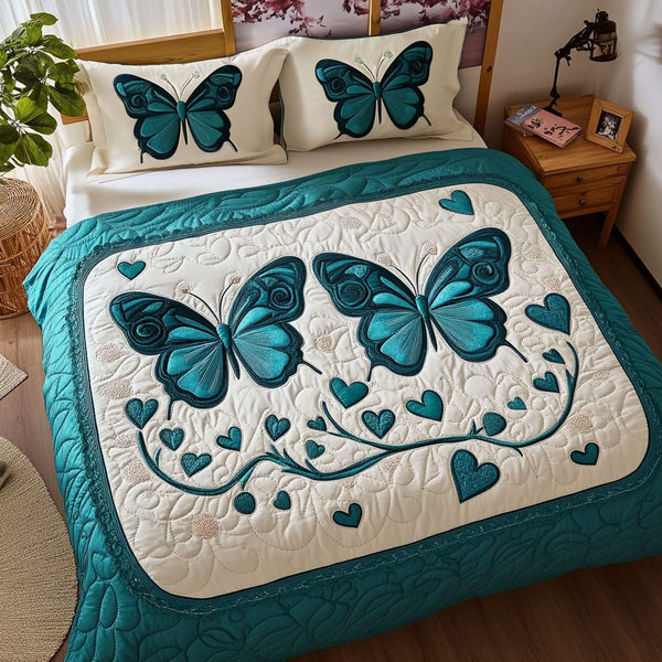 Fluttery Love quilted 3-piece bedding set on a made bed with two matching pillow shams