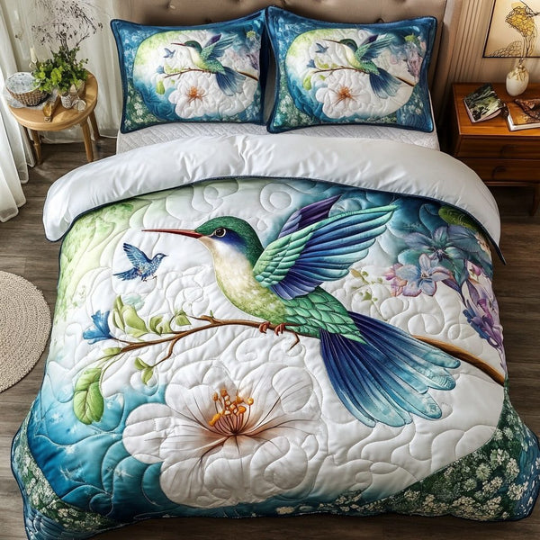 Flying Hummingbird quilted 3-piece bedding set on a made bed with two matching pillow shams