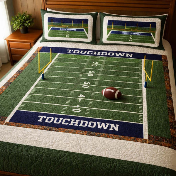 Football Field quilted 3-piece bedding set on a made bed with two matching pillow shams
