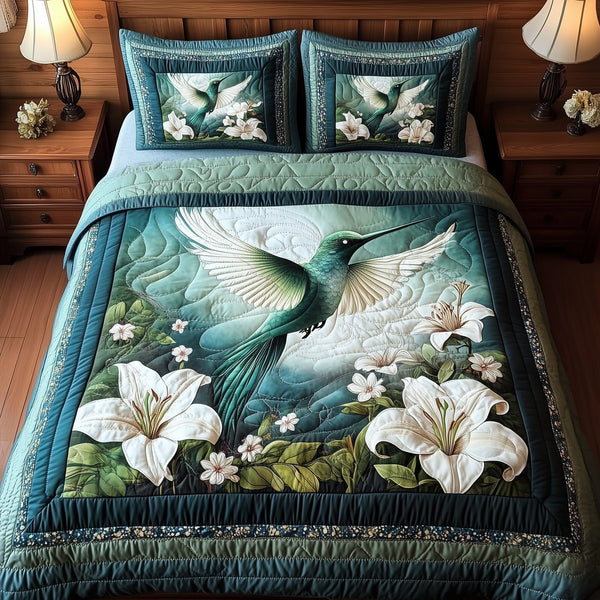Forestlight Hummingbird quilted 3-piece bedding set on a made bed with two matching pillow shams