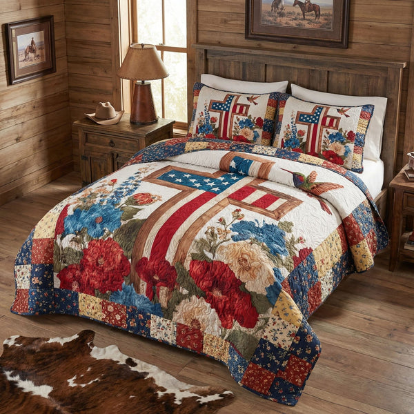 Freedom Garden Blessing quilted 3-piece bedding set on a made bed in a warmly lit bedroom