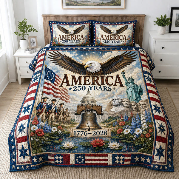 Freedom Legacy quilted 3-piece bedding set on a made bed in a warmly lit bedroom